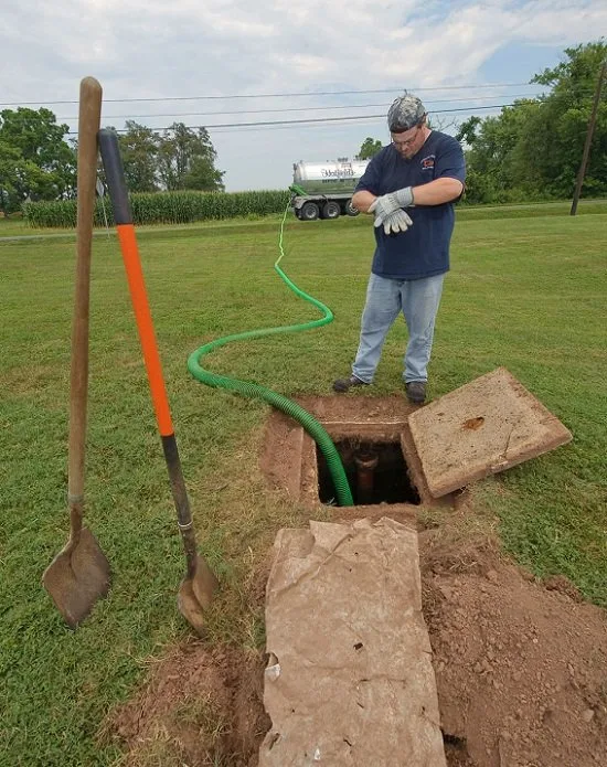 Septic pumping equipment being used at an open septic access point.